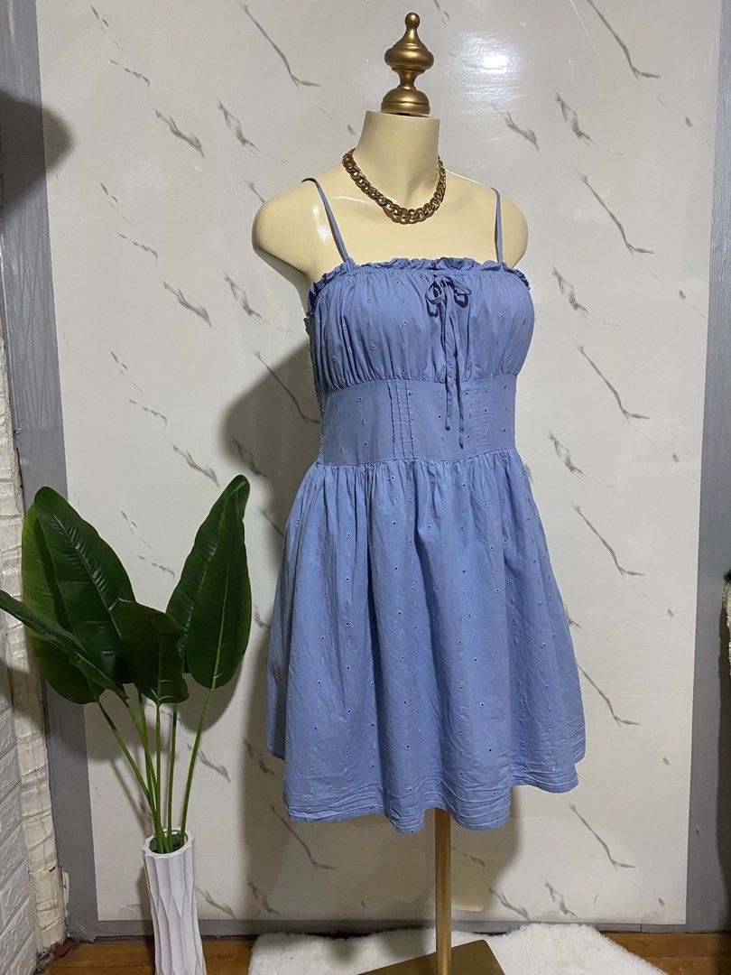 Blue Eyelet Ruffle Strap Mini Dress (Category: Dresses) located in Taguig. Submitted by dinoswear.ph (Listing ID 1462778031, Image 2). Description: - Adorable blue mini dress - Delicate eyelet details - Flattering ruffled neckline - Chic tie-front design - Comfortable smocked back - Adjustable spaghetti straps - Perfect for summer vibes or casual outings - Effortless to wear and style.