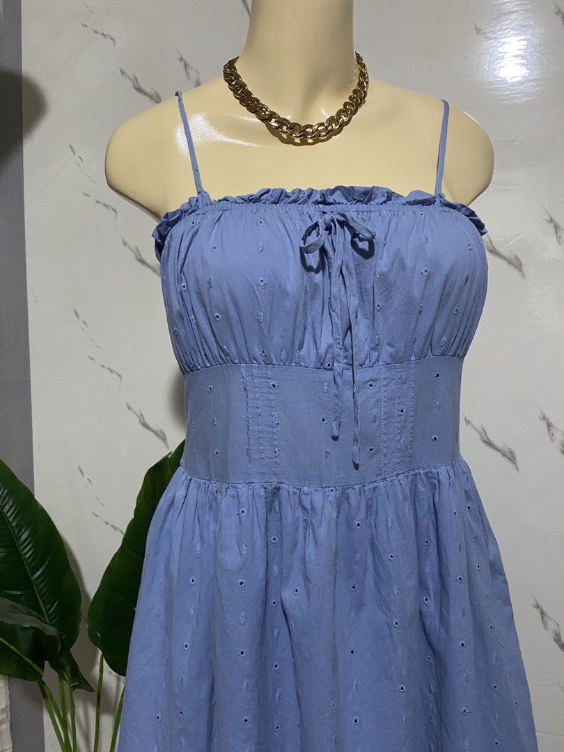 Blue Eyelet Ruffle Strap Mini Dress (Category: Dresses) located in Taguig. Submitted by dinoswear.ph (Listing ID 1462778031, Image 3). Description: - Adorable blue mini dress - Delicate eyelet details - Flattering ruffled neckline - Chic tie-front design - Comfortable smocked back - Adjustable spaghetti straps - Perfect for summer vibes or casual outings - Effortless to wear and style.