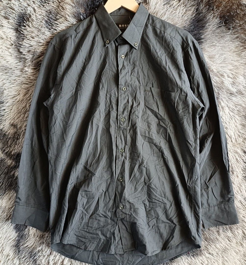 BOSS Hugo Boss Men's Button-down (Category: Tshirts & Polo Shirts ) located in Butuan. Submitted by luxestreet04 (Listing ID 1462724592, Image 1). Description: - Classic BOSS Hugo Boss button-up shirt - Color: Dark Grey - Style: Long sleeves with button cuffs - Features: Chest pocket, button-down collar - Material: Cotton-polyester blend - Versatile: Ideal for smart casual or formal wear - Condition: Please check photos for detailed condition.