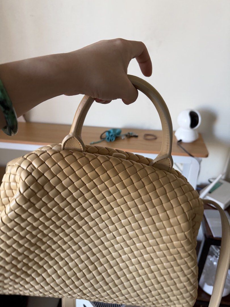 Botegga Leather Top Handle Bag (Category: Shoulder Bags) located in Quezon City. Submitted by sourcemanila (Listing ID 1462865623, Image 3). Description: - interracio padded top handle - Cream woven leather handbag - Features a top handle - Includes a detachable shoulder strap - Intricate and detailed weave - Spacious interior - Versatile for daily use or special occasions - A classic piece that complements any outfit.