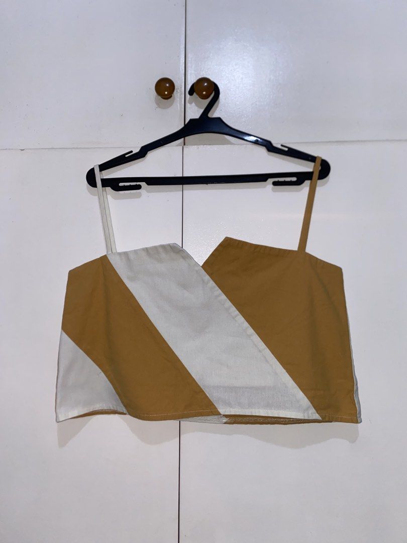 Brown and White Striped Asymmetrical Crop Top (Category: Others Tops) located in Quezon City. Submitted by addy_addy (Listing ID 1462815816, Image 1). Description: - Cute asymmetrical crop top - Bold brown and white stripe pattern - Breathable, light linen-blend fabric - Ideal for casual outings or beach trips - Versatile: pairs easily with shorts or skirts - Approximate measurements: •Bust (A-cut): 44 cm (upper hem); 48 cm (lower hem) • Length: 