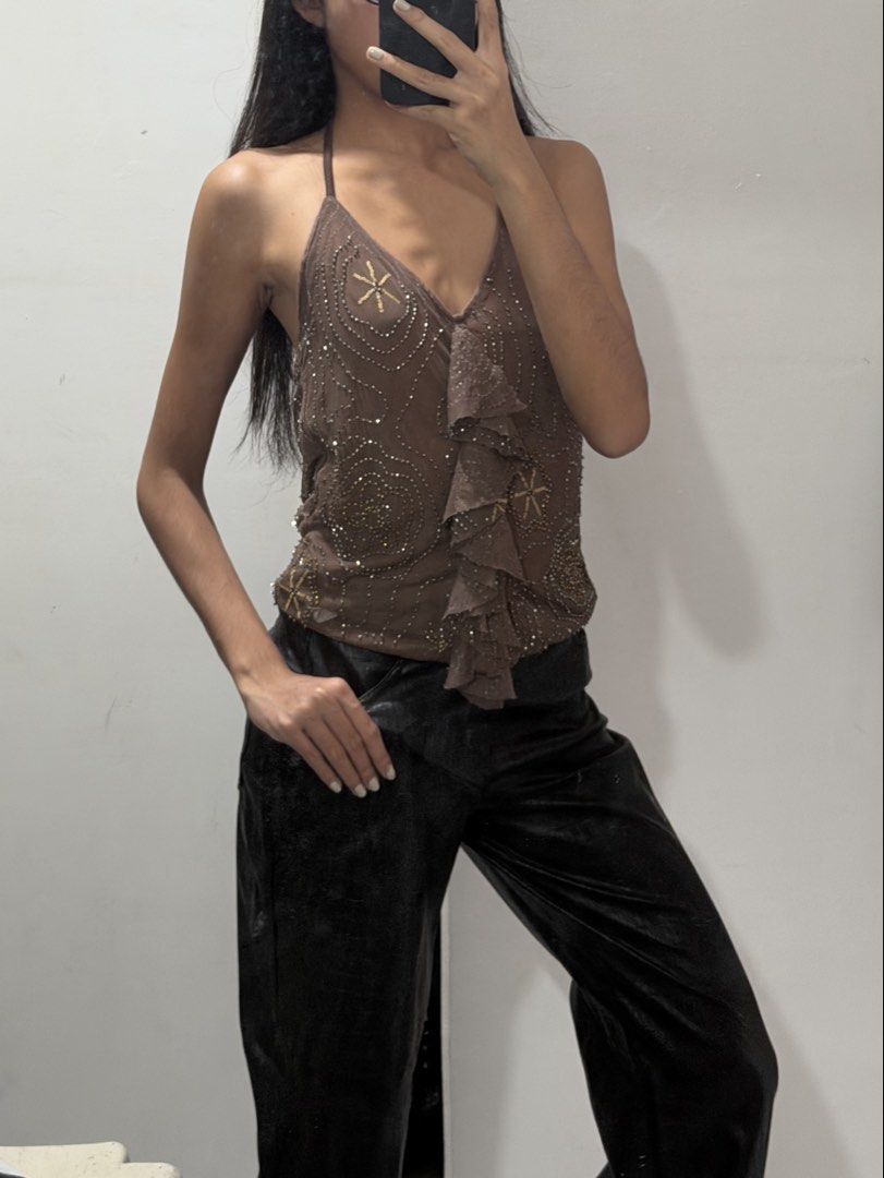 Brown Beaded Halter Top with Ruffles (Category: Sleeveless) located in Pasig City. Submitted by miss_abuelita (Listing ID 1462777587, Image 2). Description: - Cute brown halter top - Beaded details all over - Ruffled front - Straps tie at the neck - Versatile: pairs well with jeans or trousers - Ideal for night outs or special occasions - Unique piece.
