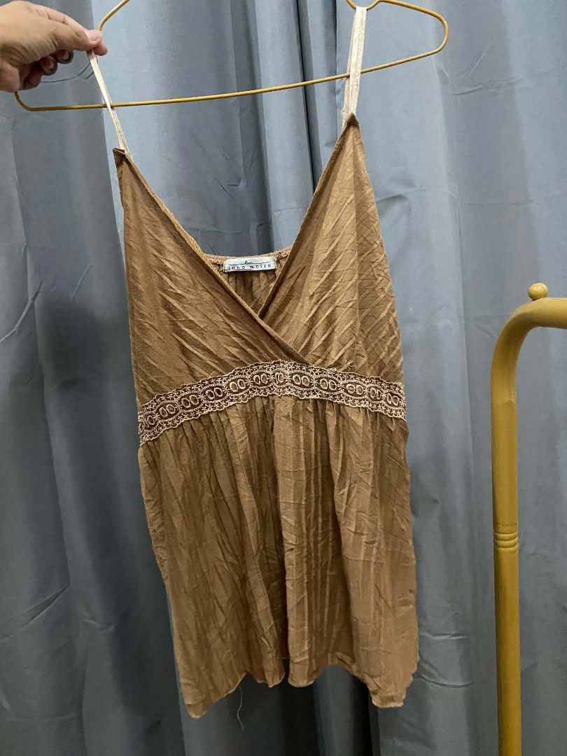 Brown Lace Trim Camisole Top (Category: Sleeveless) located in Malasiqui. Submitted by finnley26 (Listing ID 1462691834, Image 1). Description: - Chic brown camisole top - Delicate lace trim detail - Adjustable spaghetti straps for a perfect fit - Flattering V-neckline with a wrap-around effect - Unique crinkled fabric texture - Ideal for layering or as a standalone piece - Combines comfort and style UPTO MEDIUM.