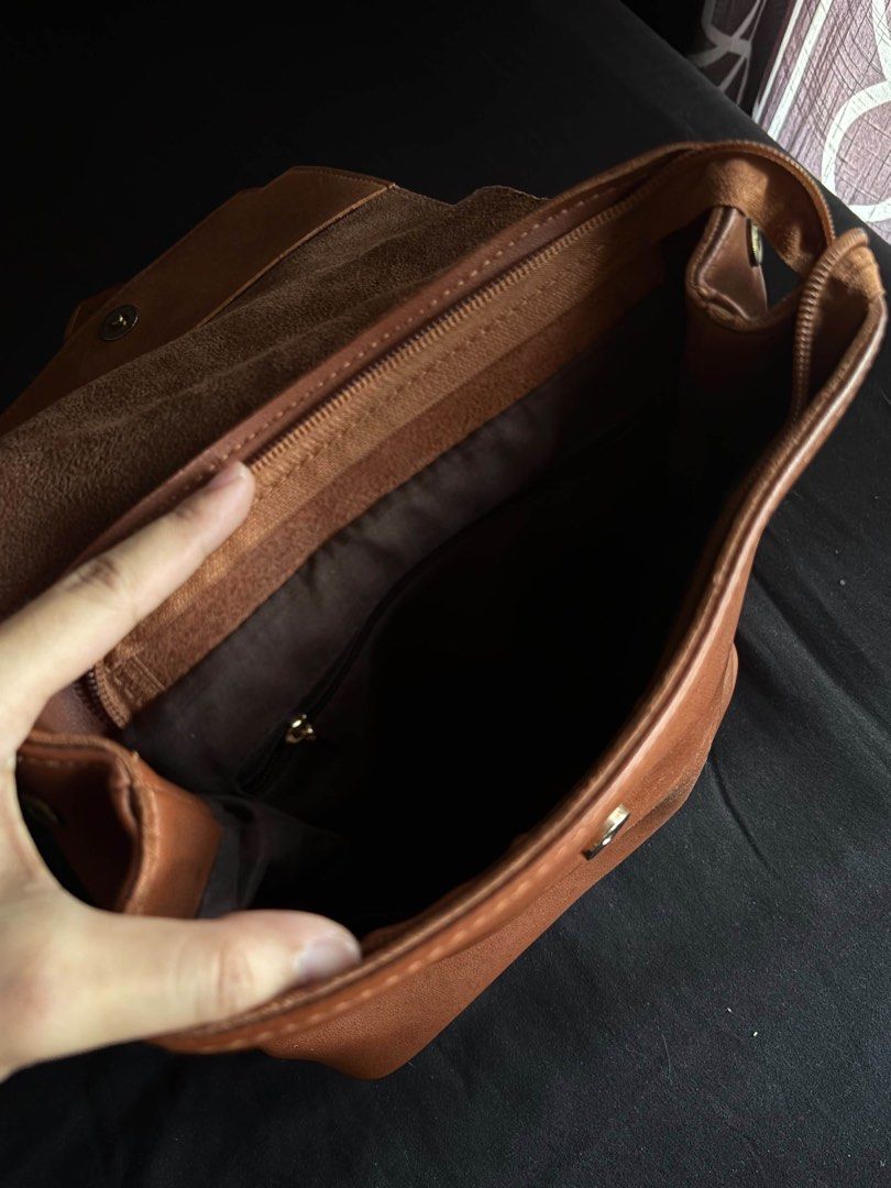 Brown Leather Backpack (Category: Backpacks) located in Calamba. Submitted by leeadriannn796 (Listing ID 1462713231, Image 3). Description: - Genuine brown leather backpack - Secure zip closure on top - Front flap with decorative metal buckle - Adjustable shoulder straps for comfort - Interior zip pocket and slip pockets for organization - Ideal for everyday adventures and work.