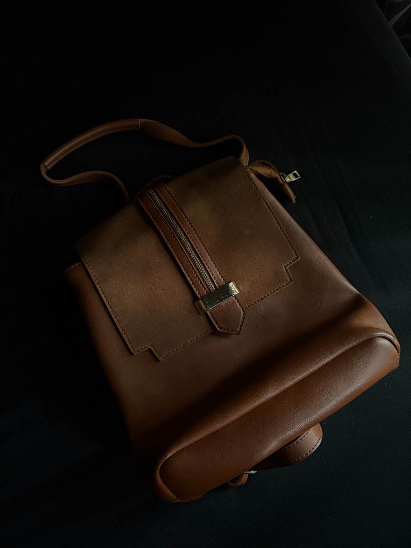 Brown Leather Backpack (Category: Backpacks) located in Calamba. Submitted by leeadriannn796 (Listing ID 1462713231, Image 1). Description: - Genuine brown leather backpack - Secure zip closure on top - Front flap with decorative metal buckle - Adjustable shoulder straps for comfort - Interior zip pocket and slip pockets for organization - Ideal for everyday adventures and work.