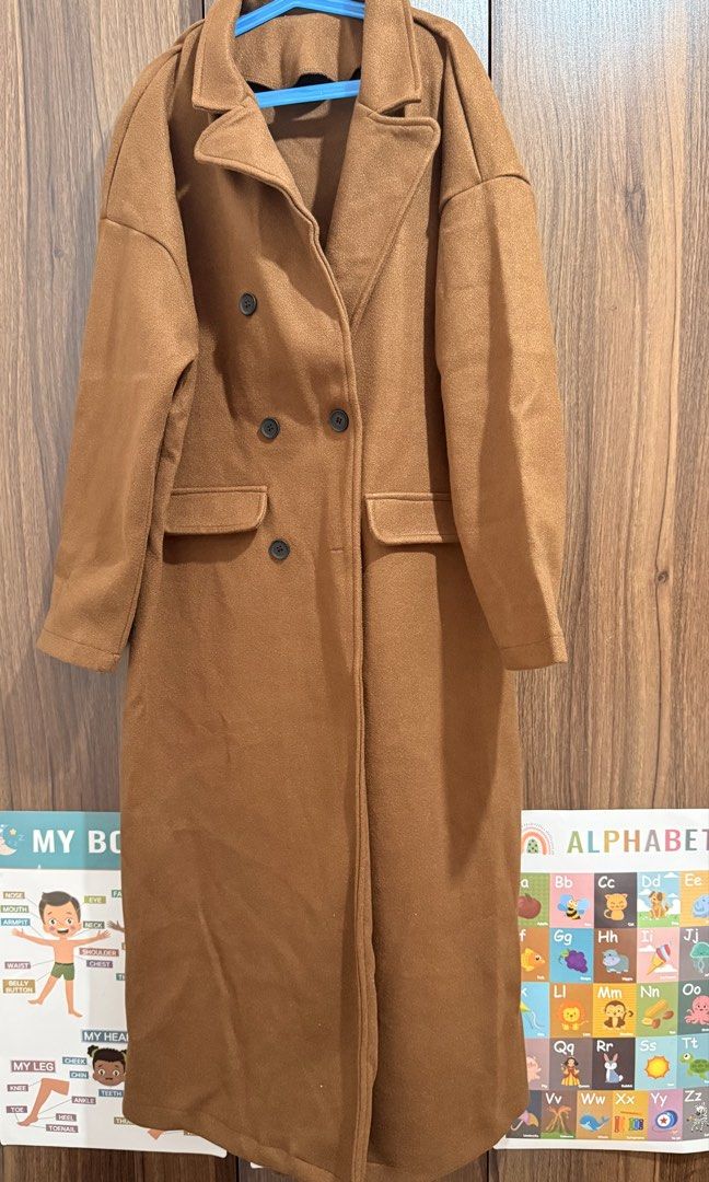Brown Long Coat/Trench Coat (Category: Coats, Jackets and Outerwear) located in General Trias. Submitted by tinyfits_outgrown (Listing ID 1462884482, Image 1). Description: - Classic brown coat - Button closure - Warm and cozy feel - Ideal for cooler weather - Size: Medium (M) Unused.