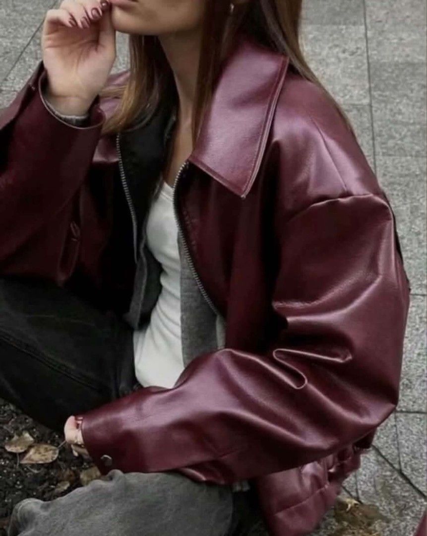 Burgundy Red Leather Jacket (Category: Coats, Jackets and Outerwear) located in Paranaque City. Submitted by lizzyscloset01 (Listing ID 1462792789, Image 2). Description: - Cool burgundy faux leather bomber jacket - Oversized fit - Zip-up front - Attached grey hoodie layer - Versatile for pairing with jeans or trousers - Ideal for a casual, edgy style - Great for layering.