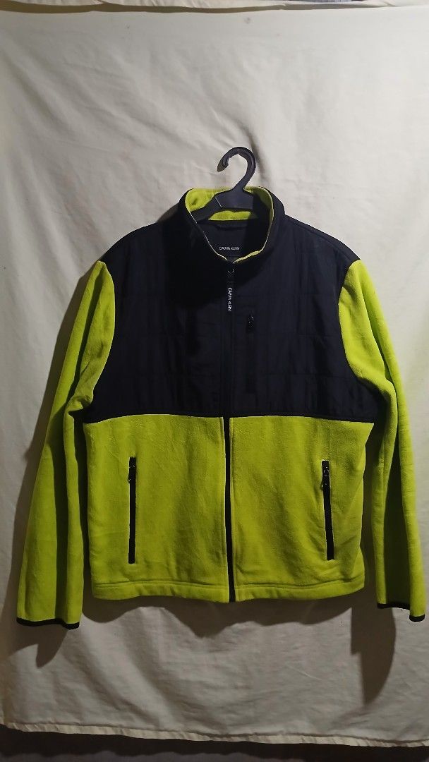 Calvin Klein Colorblock Fleece Jacket (Category: Coats, Jackets and Outerwear) located in Caloocan City. Submitted by vincefresn21903 (Listing ID 1462681835, Image 1). Description: - Cool Calvin Klein jacket - Black and bright green colorblock design - Full zip front - Zippered pockets - Soft fleece material inside - Great for layering or wearing on its own - Good for casual wear or outdoor activities.