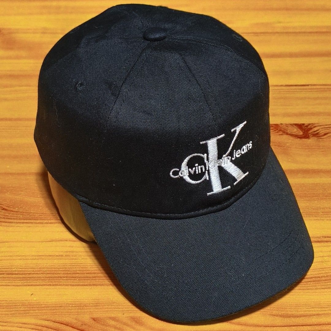 Calvin Klein Jeans Black CK Embroidered Baseball Cap (Category: Caps & Hats) located in Manila. Submitted by caps08 (Listing ID 1462875583, Image 1). Description: - Classic black Calvin Klein Jeans cap - Features the iconic CK logo embroidered on the front - Adjustable strap at the back with a metal buckle for a custom fit - Simple and versatile design, perfect for everyday wear.