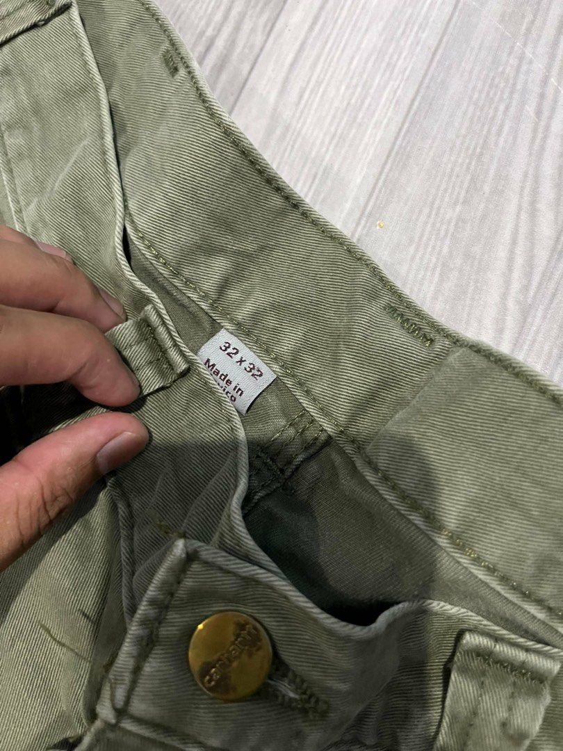 Carhartt Work Pants Khaki Size 32x32 (Category: Jeans) located in Siniloan. Submitted by marceiron316276 (Listing ID 1462805087, Image 3). Description: - Carhartt Work Pants - Color: Khaki - Size: 32 Waist x 32 Inseam - Style: Classic Carpenter Pants - Features: Multiple pockets, hammer loop - Material: Durable Canvas - Origin: Made in Mexico - Condition: Used, with some signs of wear including a small tear on the lower leg..