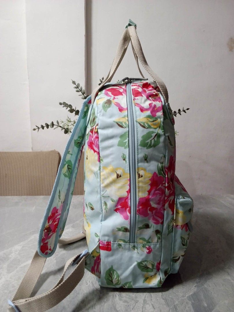 Cath Kidston Floral Backpack (Category: Backpacks) located in Manila. Submitted by cosmiccloud-9236 (Listing ID 1462748176, Image 3). Description: - Adorable floral print backpack - Light blue base with pink, yellow, and green flowers - Convenient front pocket - Adjustable straps for a comfortable fit - Secure zip closure - Ideal for everyday use or travel - Brand logo visible on front pocket.