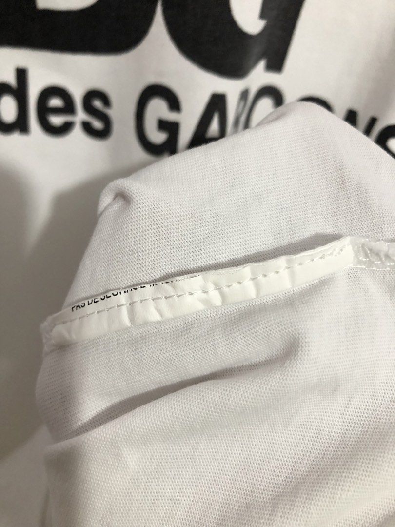 CDG Comme des Garçons White T-Shirt (Category: Luxury Apparel) located in Quezon City. Submitted by clarizedeo09960 (Listing ID 1462790209, Image 3). Description: - White Comme des Garçons (CDG) T-shirt - Features the classic CDG logo print on the front - Made from good quality cotton - Simple, stylish, and great for everyday casual wear - Please check photos for detailed condition.