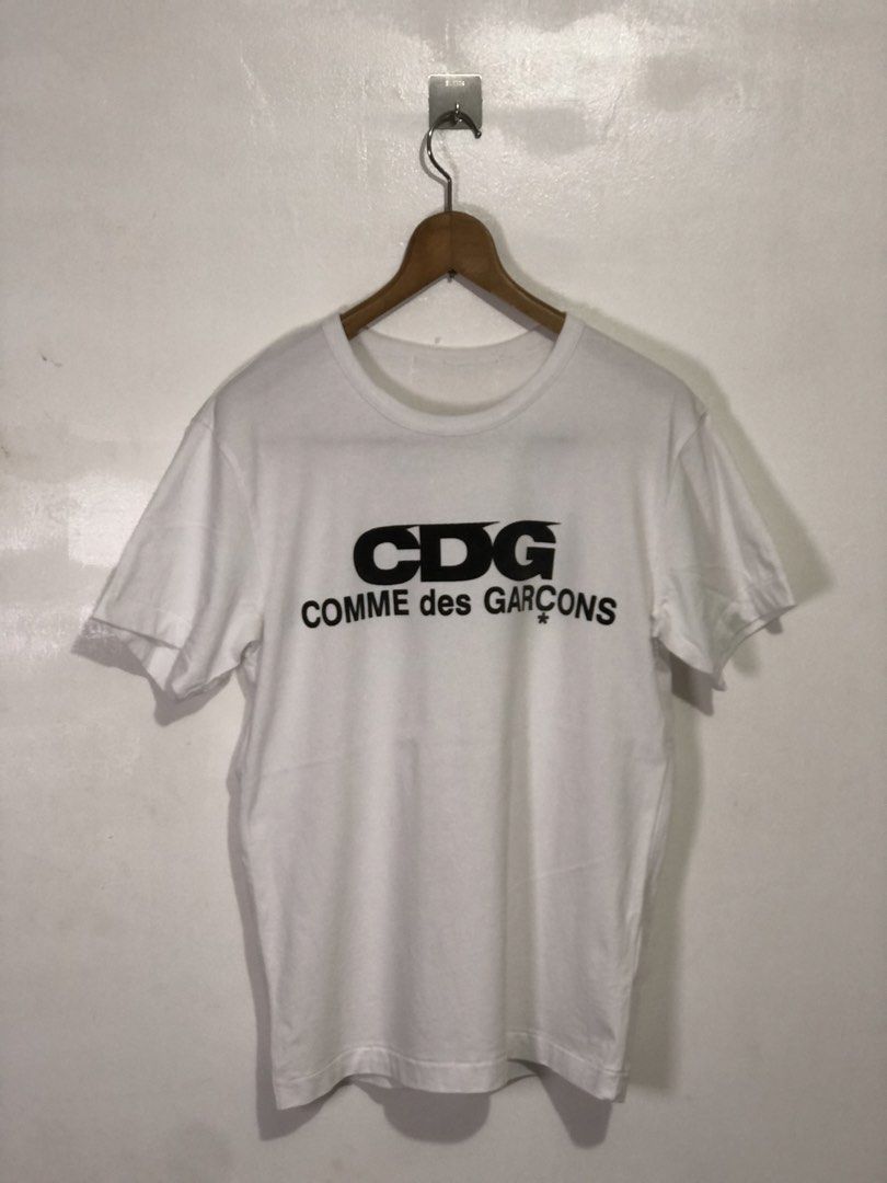 CDG Comme des Garçons White T-Shirt (Category: Luxury Apparel) located in Quezon City. Submitted by clarizedeo09960 (Listing ID 1462790209, Image 1). Description: - White Comme des Garçons (CDG) T-shirt - Features the classic CDG logo print on the front - Made from good quality cotton - Simple, stylish, and great for everyday casual wear - Please check photos for detailed condition.