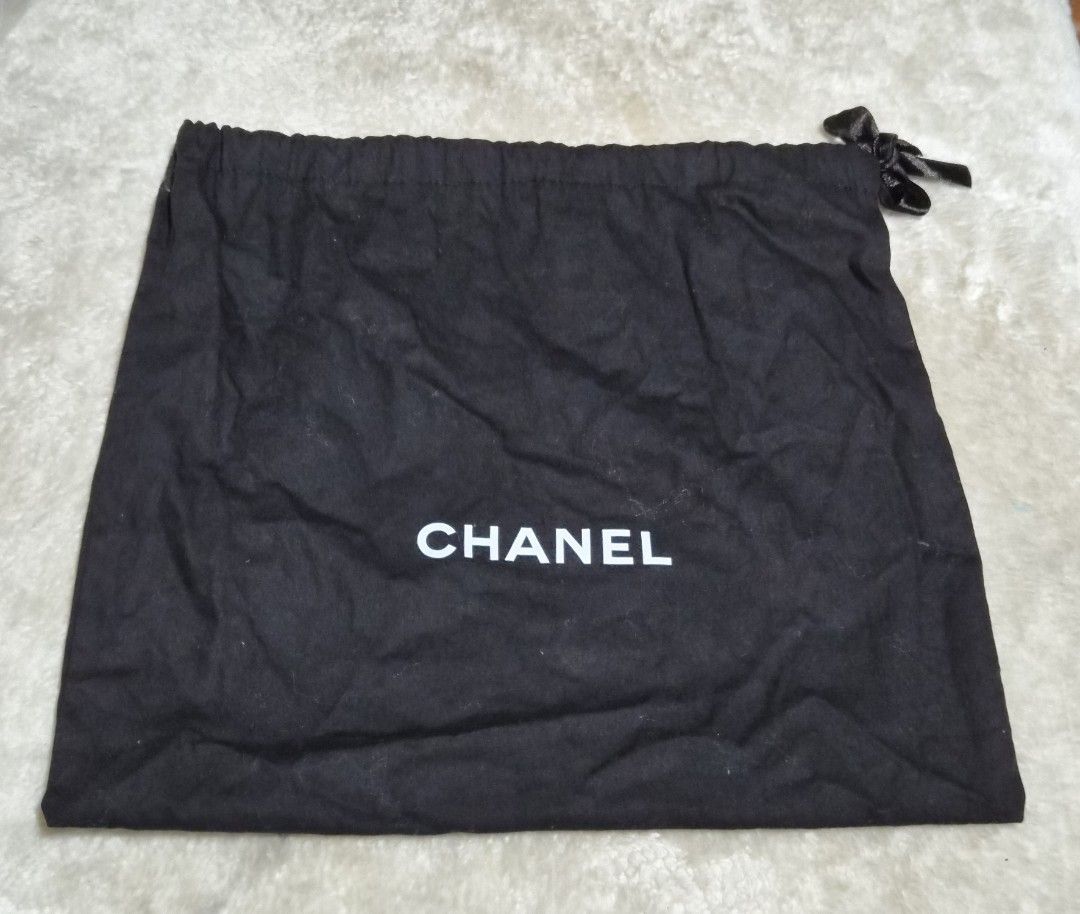 Chanel Dust Bag (Category: Children's Beds) located in Mandaue City. Submitted by chuchi152615 (Listing ID 1462715860, Image 1). Description: - Chanel dust bag - Classic black fabric with iconic white Chanel logo - Secure drawstring closure - Ideal for protecting handbags or shoes - Approximate dimensions: 14 inches (height) x 12 inches (width).