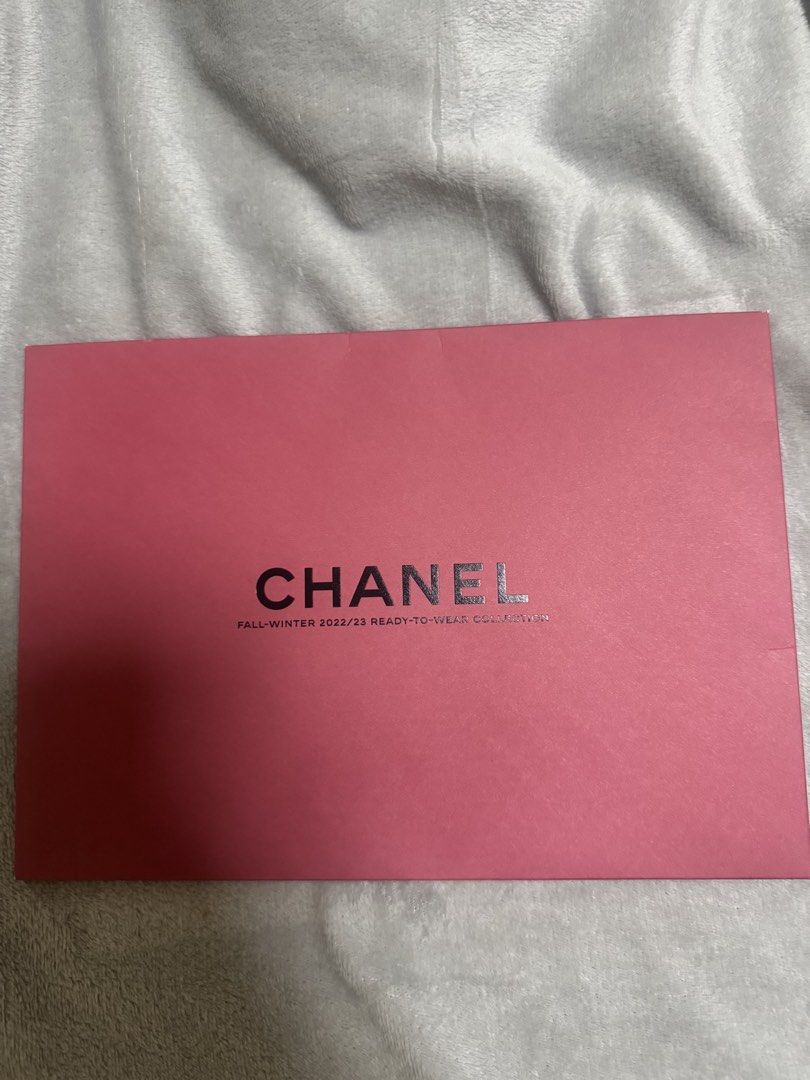 Chanel Fall-Winter 2022/23 Collection Newspaper (Category: Luxury Bags & Wallets) located in Manila. Submitted by quintessesommerset (Listing ID 1462767054, Image 1). Description: - Chanel Fall-Winter 2022/23 Ready-to-Wear Collection - Comes in a pink magnetic envelope - Features a stylish image of a model's legs wearing Chanel socks and shoes - Ideal for Chanel collectors and enthusiasts - A unique addition to any collection.