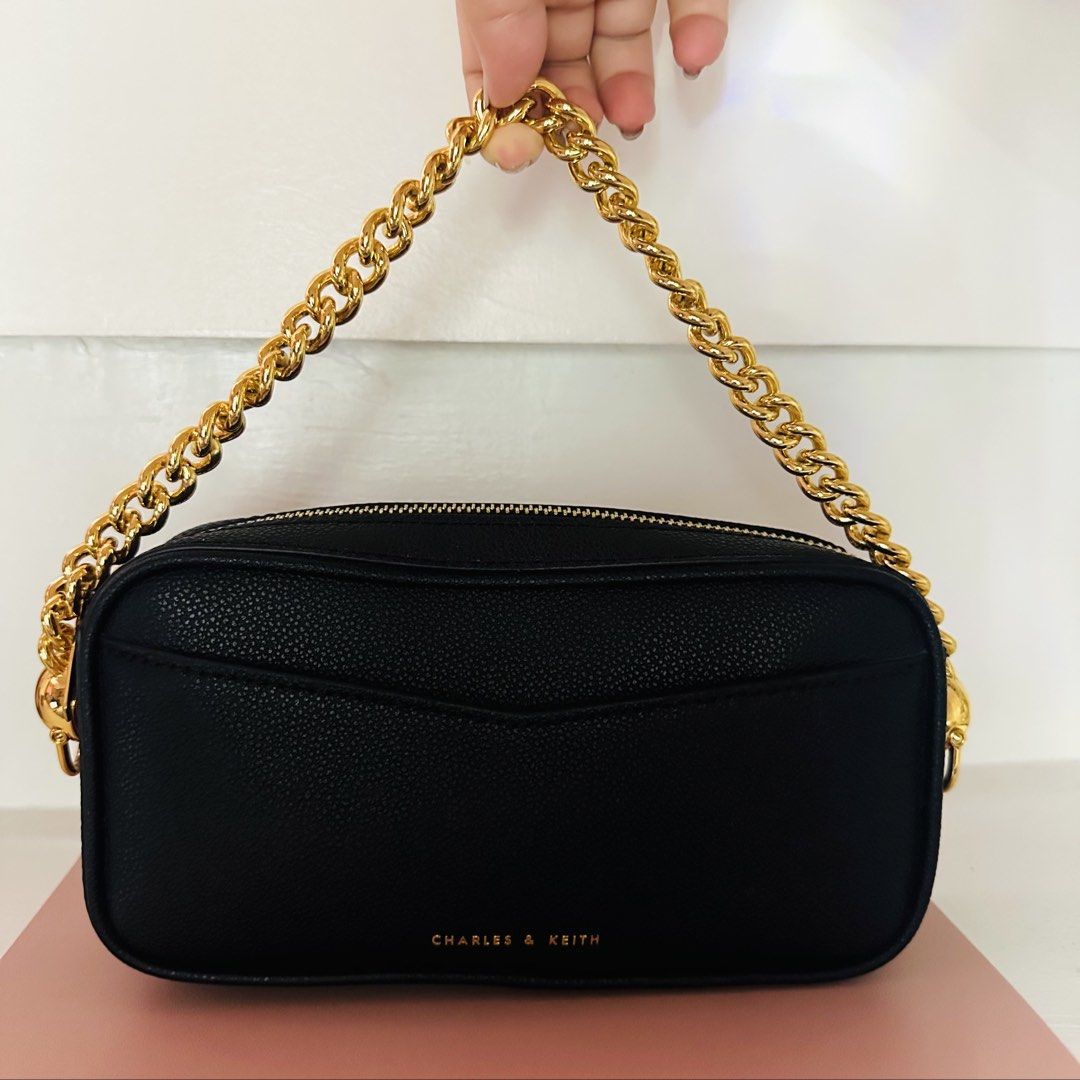 Charles & Keith Black Crossbody Bag (Category: Cross-body Bags) located in Makati City. Submitted by xiaolongbabi (Listing ID 1462729036, Image 2). Description: ‼️ Used only once‼️ - classic black design with gold chain strap - compact and easy to style — perfect for everyday use or going out - comes with a strap for crossbody wear Condition: 10/10 – used once, well kept Size: Small Style: Crossbody / Hand Bag MOP: Gcash / BDO Delivery: 📍Makati 