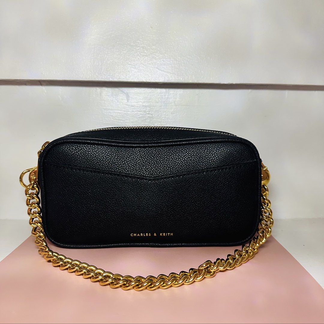 Charles & Keith Black Crossbody Bag (Category: Cross-body Bags) located in Makati City. Submitted by xiaolongbabi (Listing ID 1462729036, Image 1). Description: ‼️ Used only once‼️ - classic black design with gold chain strap - compact and easy to style — perfect for everyday use or going out - comes with a strap for crossbody wear Condition: 10/10 – used once, well kept Size: Small Style: Crossbody / Hand Bag MOP: Gcash / BDO Delivery: 📍Makati 