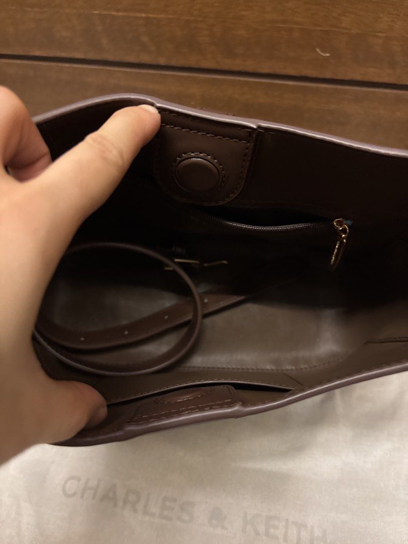 Charles & Keith Brown Shoulder Bag (Category: Shoulder Bags) located in Paranaque City. Submitted by corinne_see (Listing ID 1462838864, Image 3). Description: - Brand: Charles & Keith - Color: Brown - Style: Shoulder bag - Features: Gold buckle detail on front, interior zipped pocket, interior slip pocket - Includes: Original dust bag - Ideal for: Everyday use.