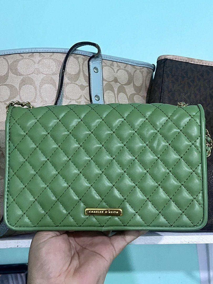 Charles & Keith Green Quilted Shoulder Bag (Category: Shoulder Bags) located in Manila. Submitted by cleverstone_21f597 (Listing ID 1462710153, Image 2). Description: - Cute green shoulder bag from Charles & Keith - Stylish quilted design - Gold hardware and clasp closure - Convenient chain strap - Interior zip pocket and card slots - Versatile for going out or everyday wear - Easily matches various outfits.