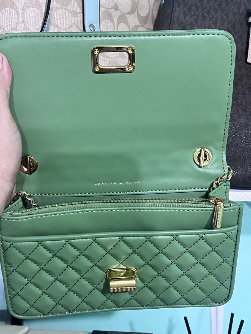 Charles & Keith Green Quilted Shoulder Bag (Category: Shoulder Bags) located in Manila. Submitted by cleverstone_21f597 (Listing ID 1462710153, Image 3). Description: - Cute green shoulder bag from Charles & Keith - Stylish quilted design - Gold hardware and clasp closure - Convenient chain strap - Interior zip pocket and card slots - Versatile for going out or everyday wear - Easily matches various outfits.