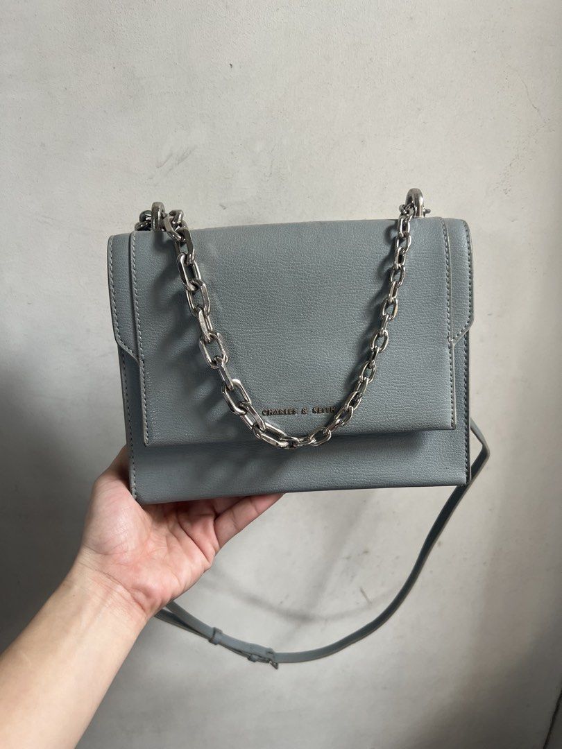 Charles & Keith Grey Chain Shoulder Bag (Category: Shoulder Bags) located in Pasig City. Submitted by x0829 (Listing ID 1462865106, Image 2). Description: - Grey shoulder bag by Charles & Keith - Features a chunky silver chain strap - Versatile: can be worn as a crossbody - Interior is clean - Minimal signs of wear - Ideal for daily use or nights out.