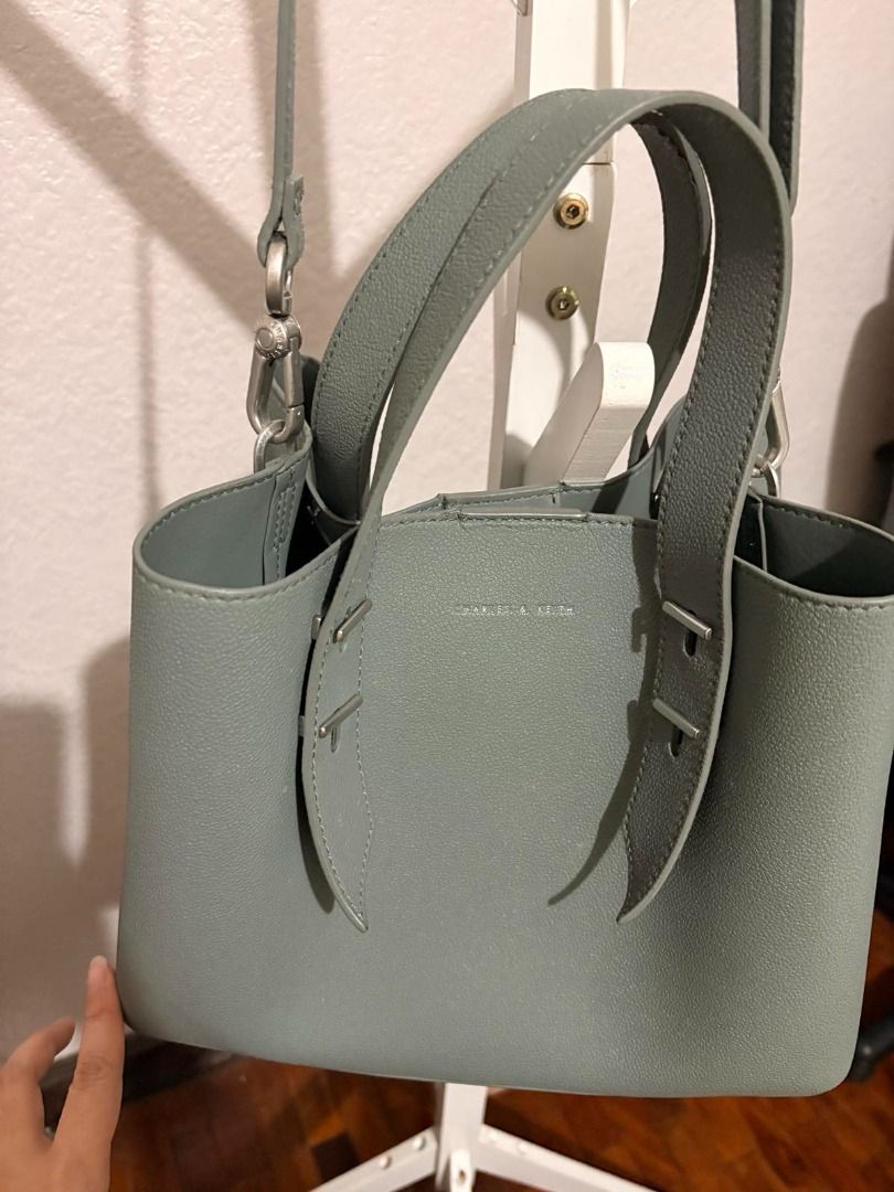 Charles & Keith Grey Handbag with Pouch (Category: Purses & Pouches) located in Mandaluyong City. Submitted by reginaldg0597 (Listing ID 1462741364, Image 3). Description: - Charles & Keith grey handbag set - Includes matching pouch - Top handles and detachable shoulder strap - Interior zippered compartment - Ideal for everyday or work use - Selling as a set - Bank transfer or GCash.