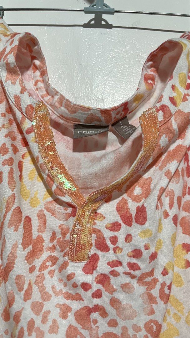 Chico's Pink Leopard Print Sequin V-Neck Top (Size 1 / US Medium (Category: Others Tops) located in Dinalupihan. Submitted by banditvaultco (Listing ID 1462845246, Image 2). Description: Brand: Chico’s Official Size: Chico’s Size 1 (Fits like a US Medium / UK 10-12) Material: Premium blend of 60% Cotton / 40% Modal for ultimate softness Condition: Excellent condition. Details: Flattering short sleeves, sequin neckline trim, relaxed fit..