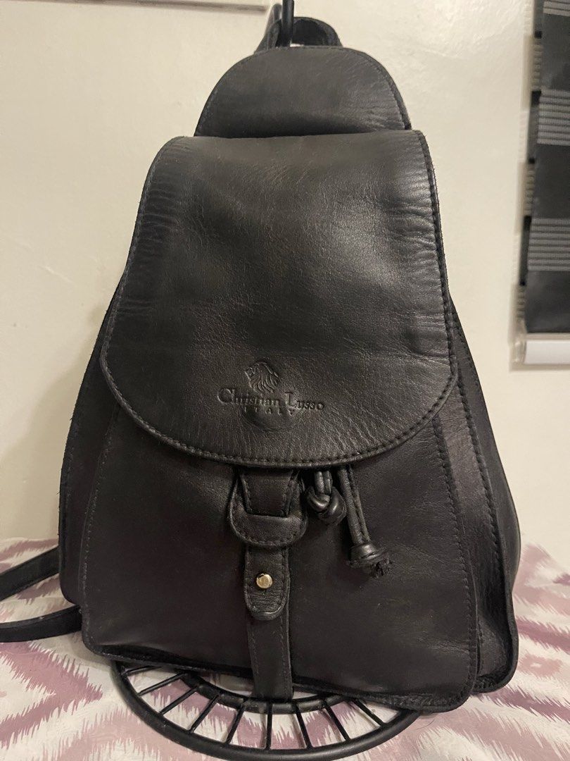 Christian Lusso Italy Black Leather Backpack (Category: Backpacks) located in General Trias. Submitted by laconchita_tesoros (Listing ID 1462727282, Image 1). Description: - Genuine black leather backpack - Brand: Christian Lusso Italy - Closure: Flap with drawstring and buckle detail - Exterior pocket: Side zippered pocket - Interior pocket: Zippered pocket - Origin: Made in Italy.
