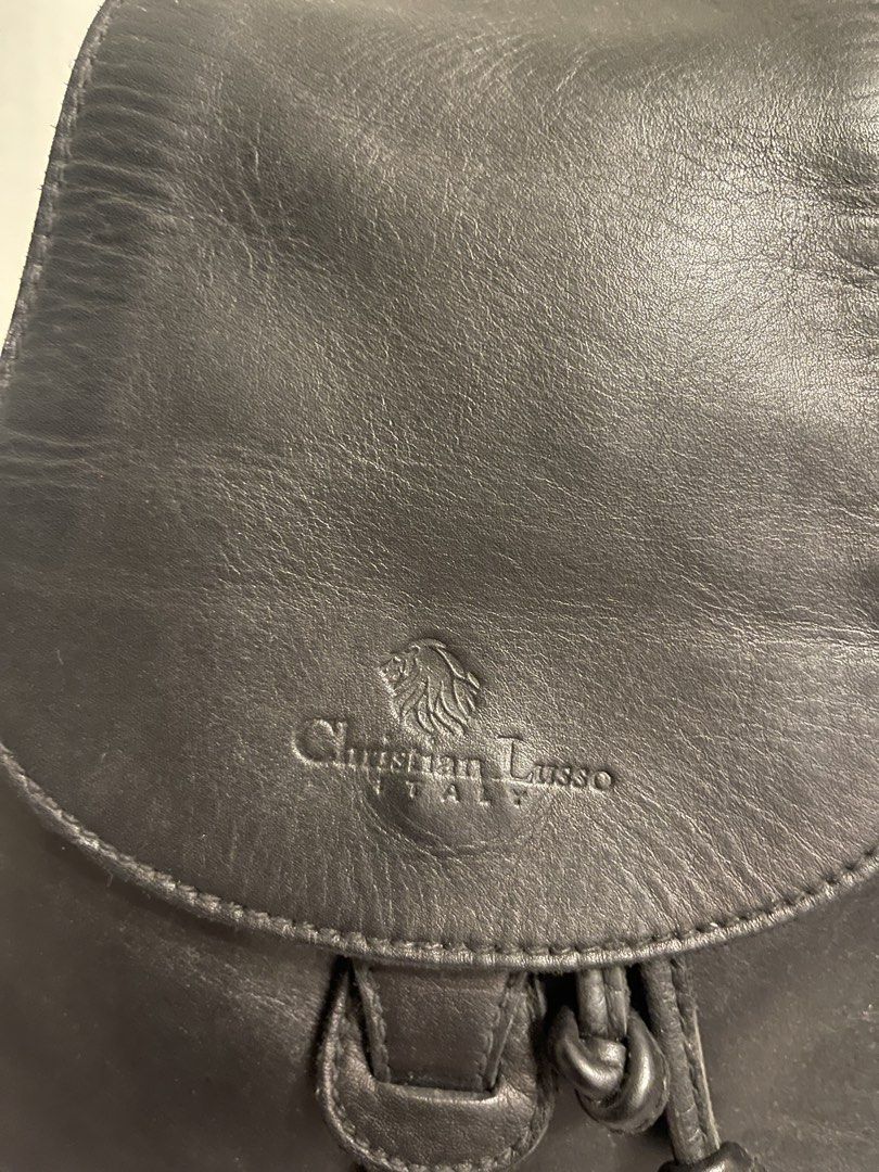 Christian Lusso Italy Black Leather Backpack (Category: Backpacks) located in General Trias. Submitted by laconchita_tesoros (Listing ID 1462727282, Image 2). Description: - Genuine black leather backpack - Brand: Christian Lusso Italy - Closure: Flap with drawstring and buckle detail - Exterior pocket: Side zippered pocket - Interior pocket: Zippered pocket - Origin: Made in Italy.