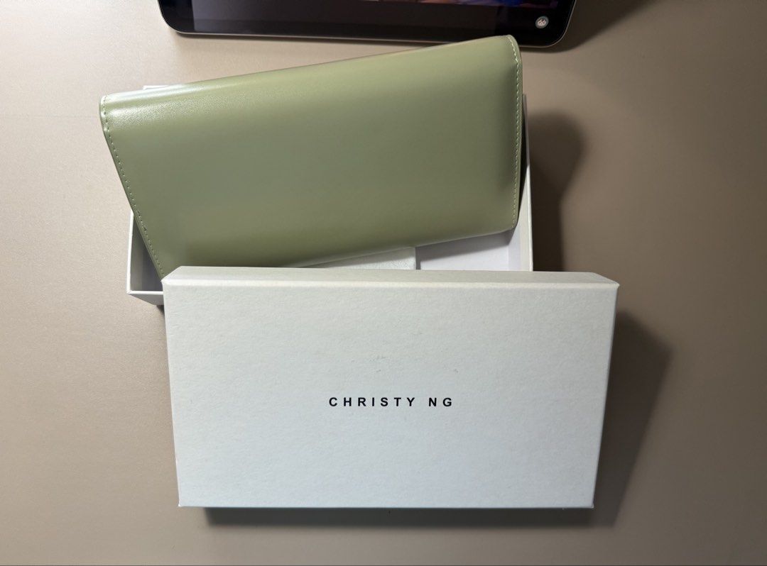 Christy Ng Long Wallet - Sage Green (Category: Wallets & Card holders) located in Manila. Submitted by tigris. (Listing ID 1462744464, Image 2). Description: - Christy Ng long wallet in elegant sage green. - Comes with original box and dust bag for safekeeping. - Ample card slots to organize your essentials. - Secure zip compartment for coins. - Chic, minimalist design with the signature Christy Ng logo. - Ideal for everyday use, blending style a
