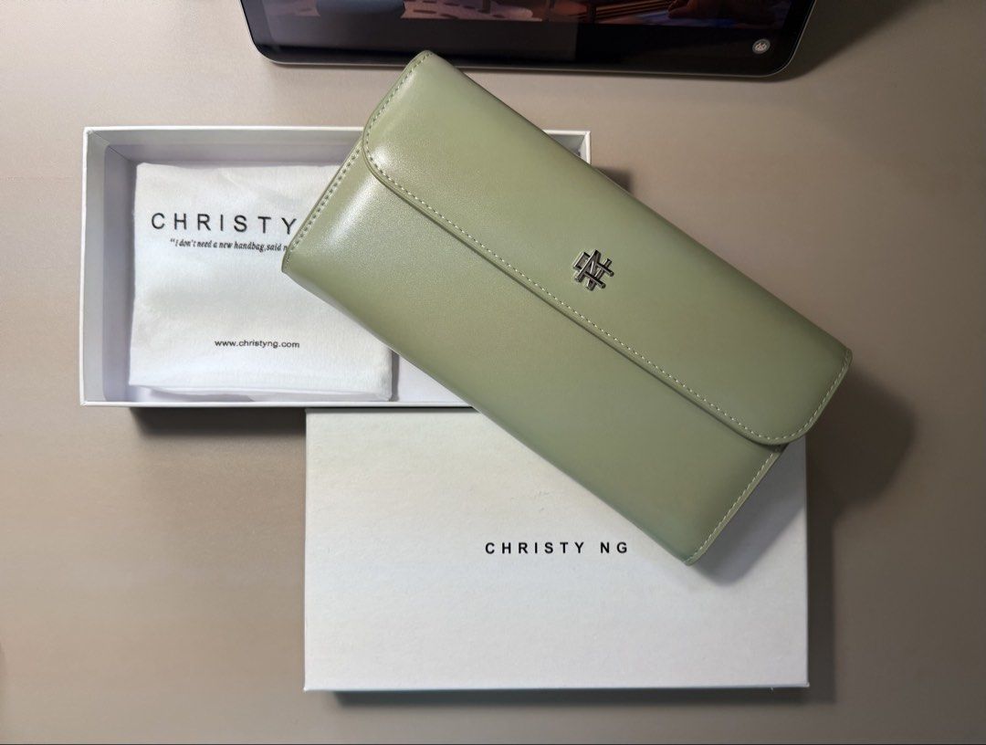 Christy Ng Long Wallet - Sage Green (Category: Wallets & Card holders) located in Manila. Submitted by tigris. (Listing ID 1462744464, Image 1). Description: - Christy Ng long wallet in elegant sage green. - Comes with original box and dust bag for safekeeping. - Ample card slots to organize your essentials. - Secure zip compartment for coins. - Chic, minimalist design with the signature Christy Ng logo. - Ideal for everyday use, blending style a