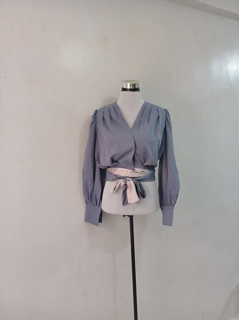 Classy Longsleeve blouse (Category: Blouses) located in Paranaque City. Submitted by janella11 (Listing ID 1462684659, Image 1). Description: - Wrap blouse - V-neckline - Gathered details at shoulders - Puff sleeves with buttoned cuffs - Includes a separate tie belt in a lighter shade - Cinch the waist for a stylish look.