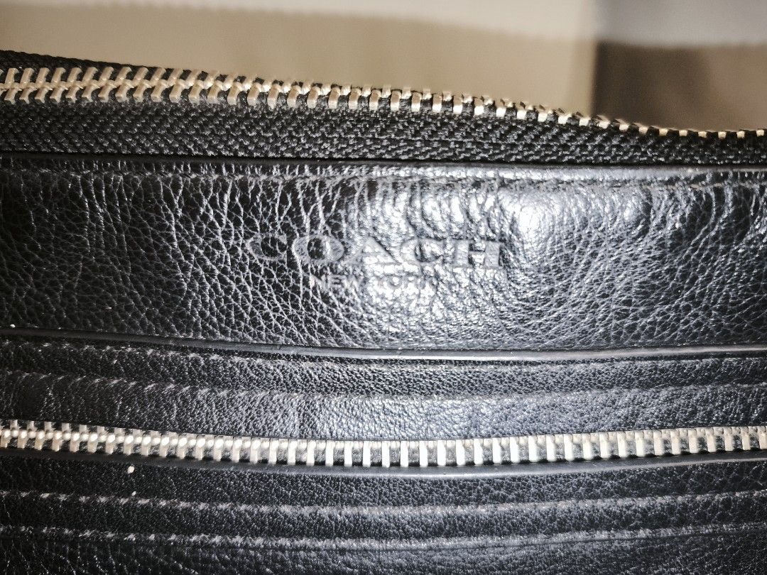 Coach Black Leather Crossbody Bag (Category: Cross-body Bags) located in Baguio. Submitted by zia_zab (Listing ID 1462821094, Image 2). Description: - Authentic Coach black leather crossbody bag - Main zippered compartment - Exterior zippered pocket - Interior zippered pocket and slip pocket - Adjustable strap with stylish striped detail - Clean interior - Minor scuffs on leather, consistent with normal use Dimes 14 x 9 x 4 inches Rubs on corners