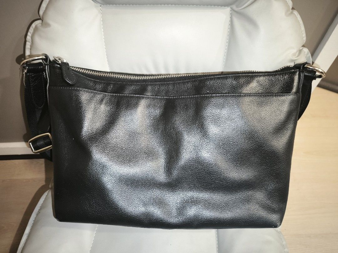 Coach Black Leather Crossbody Bag (Category: Cross-body Bags) located in Baguio. Submitted by zia_zab (Listing ID 1462821094, Image 3). Description: - Authentic Coach black leather crossbody bag - Main zippered compartment - Exterior zippered pocket - Interior zippered pocket and slip pocket - Adjustable strap with stylish striped detail - Clean interior - Minor scuffs on leather, consistent with normal use Dimes 14 x 9 x 4 inches Rubs on corners