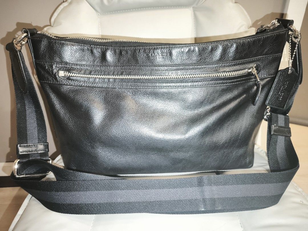 Coach Black Leather Crossbody Bag (Category: Cross-body Bags) located in Baguio. Submitted by zia_zab (Listing ID 1462821094, Image 1). Description: - Authentic Coach black leather crossbody bag - Main zippered compartment - Exterior zippered pocket - Interior zippered pocket and slip pocket - Adjustable strap with stylish striped detail - Clean interior - Minor scuffs on leather, consistent with normal use Dimes 14 x 9 x 4 inches Rubs on corners