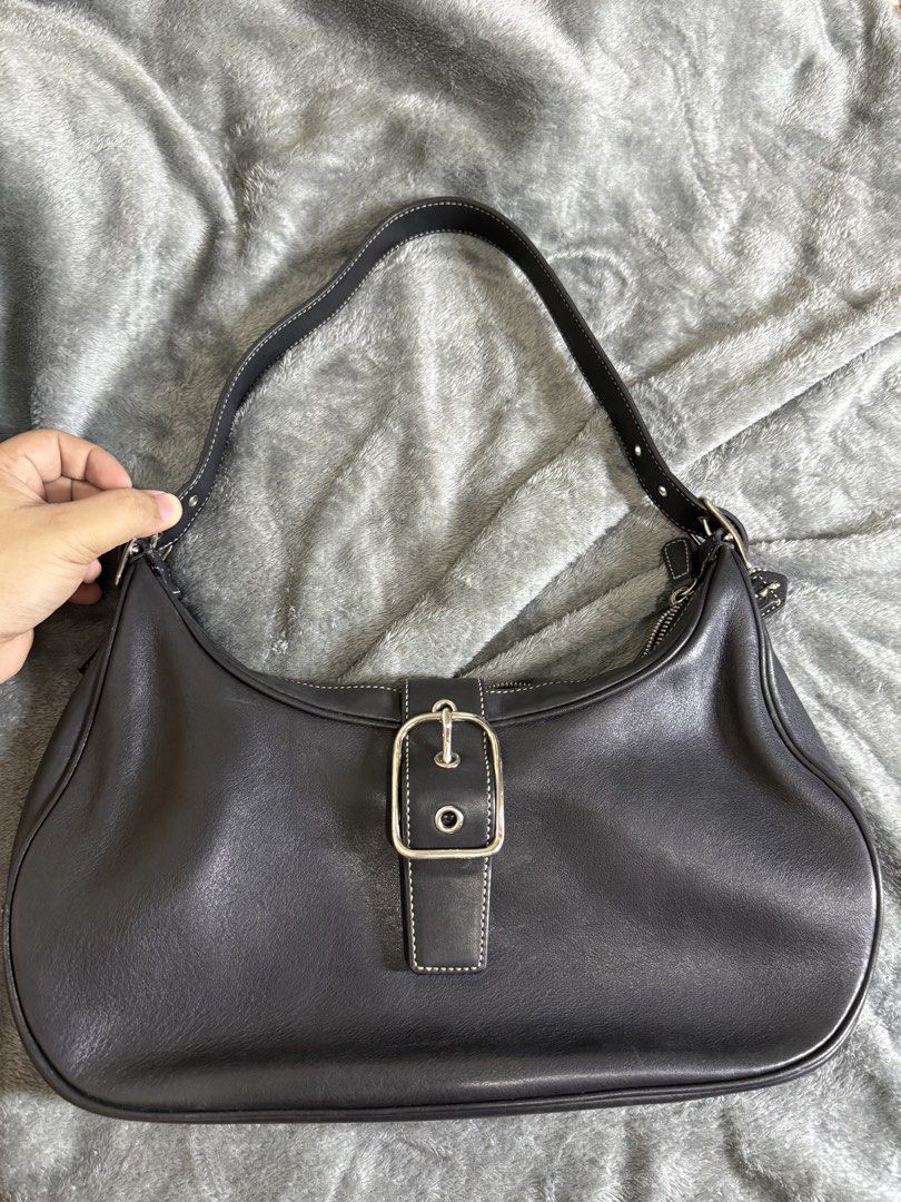 Coach Black Leather Hobo Shoulder Bag (Category: Luxury Bags & Wallets) located in Cainta. Submitted by amswardrobe (Listing ID 1462851460, Image 2). Description: - Classic black leather Coach hobo bag - Silver buckle detail on the front - Main zip compartment with interior pockets - Comfortable shoulder strap for everyday use - Versatile and practical.
