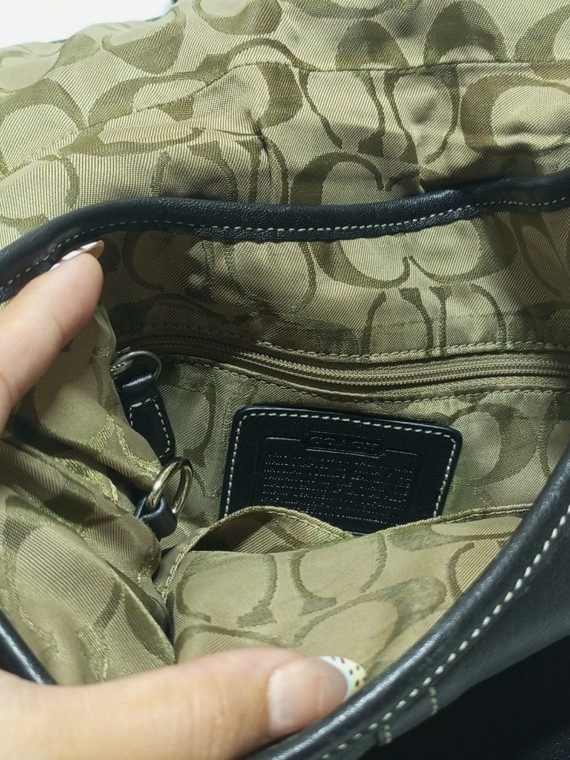 Coach Black Leather Shoulder Bag with Buckle (Category: Luxury Bags & Wallets) located in Caloocan City. Submitted by elle_f08 (Listing ID 1462687681, Image 2). Description: - Authentic Coach black leather shoulder bag - Secure buckle closure on front flap - Interior with signature Coach monogram lining - Adjustable shoulder strap for comfort - Timeless, classic design - Ideal for everyday wear.