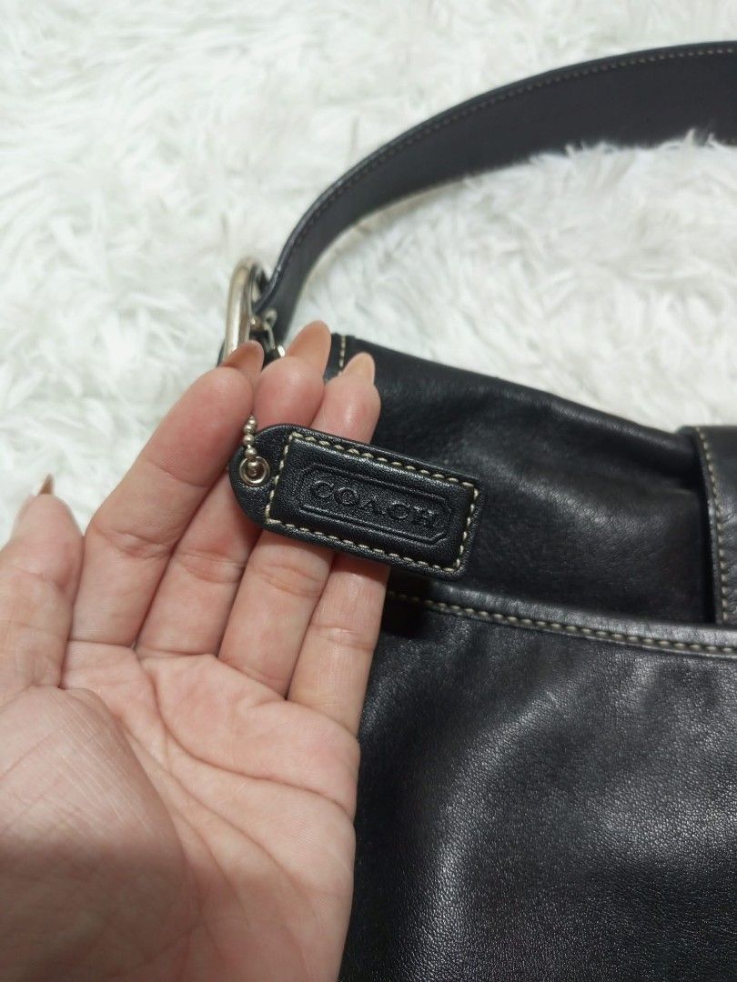Coach Black Leather Shoulder Bag with Buckle (Category: Luxury Bags & Wallets) located in Caloocan City. Submitted by elle_f08 (Listing ID 1462687681, Image 3). Description: - Authentic Coach black leather shoulder bag - Secure buckle closure on front flap - Interior with signature Coach monogram lining - Adjustable shoulder strap for comfort - Timeless, classic design - Ideal for everyday wear.