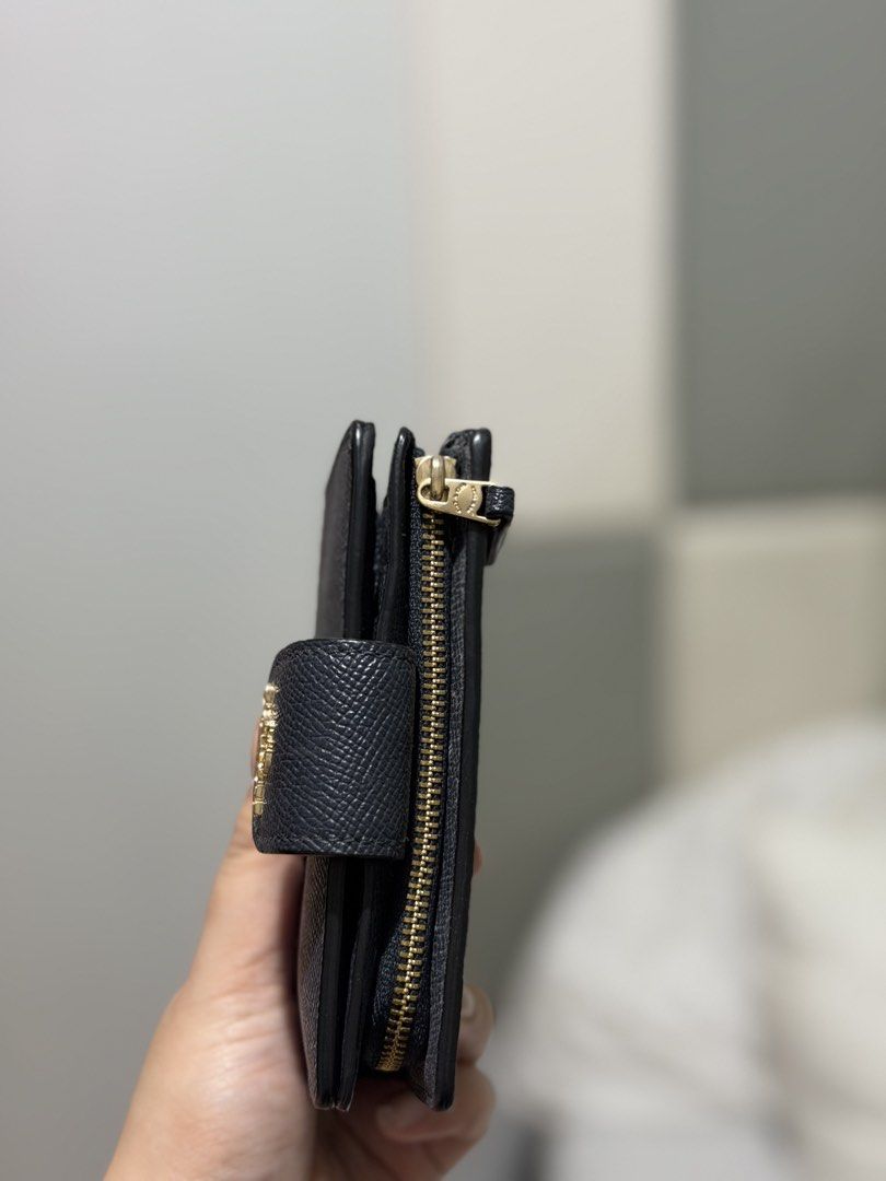 Coach medium corner zip wallet, navy blue leather with gold hardware (Category: Wallets & Card holders) located in Caloocan City. Submitted by paciojayri32680 (Listing ID 1462866003, Image 2). Description: - Coach bifold wallet - Black pebbled leather - Gold hardware details - Snap closure - Zip around coin pocket - Interior card slots - Clear ID window - Compact size, fits easily in pockets or small bags - Great for everyday use.