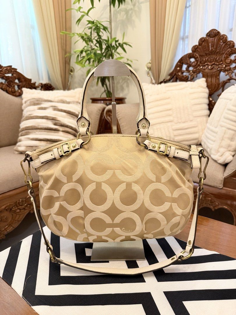 Coach Monogram Canvas Leather Trim Shoulder Bag (Category: Shoulder Bags) located in Santiago. Submitted by yrellagnoihsaf (Listing ID 1462684082, Image 3). Description: - Coach monogram canvas shoulder bag - Color: Beige and cream - Material: Leather trim and handles - Hardware: Gold details - Interior: Plenty of space - Ideal for: Everyday use issue: tarnish hardware only .