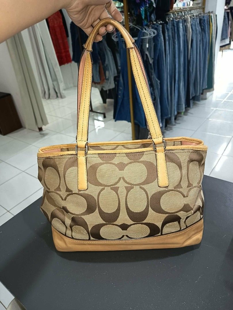 Coach Monogram Canvas Leather Trim Tote Bag (Category: Shoulder Bags) located in Antipolo. Submitted by robannrave98496 (Listing ID 1462851975, Image 2). Description: - Classic Coach tote bag - Signature monogram canvas - Tan leather trim and handles - Pink interior lining - Zipper closure - Spacious interior for essentials - Ideal for everyday use.