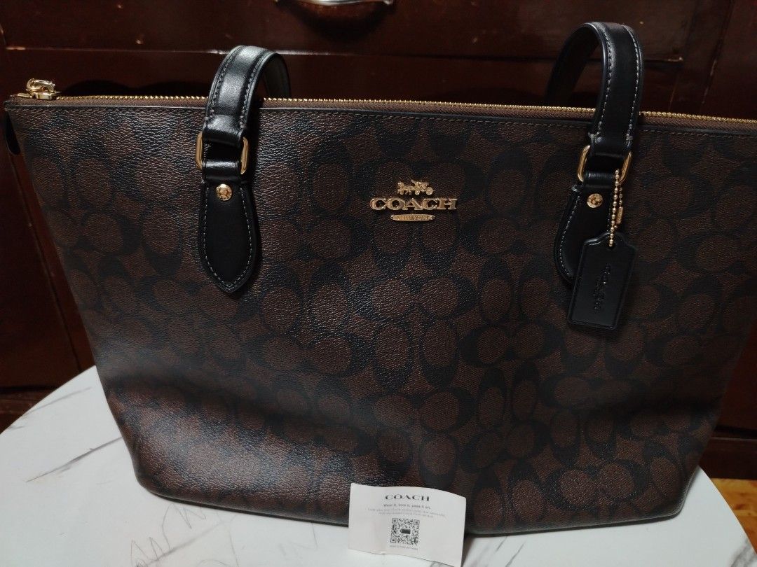 Coach Signature Brown Monogram Tote Bag (Category: Luxury Bags & Wallets) located in General Tinio. Submitted by crisantacruz (Listing ID 1462847553, Image 2). Description: - Authentic Coach tote bag - Signature brown monogram print - Elegant gold hardware details - Secure zip top closure - Includes original Coach hangtag - Interior Coach leather patch - Ideal everyday bag.