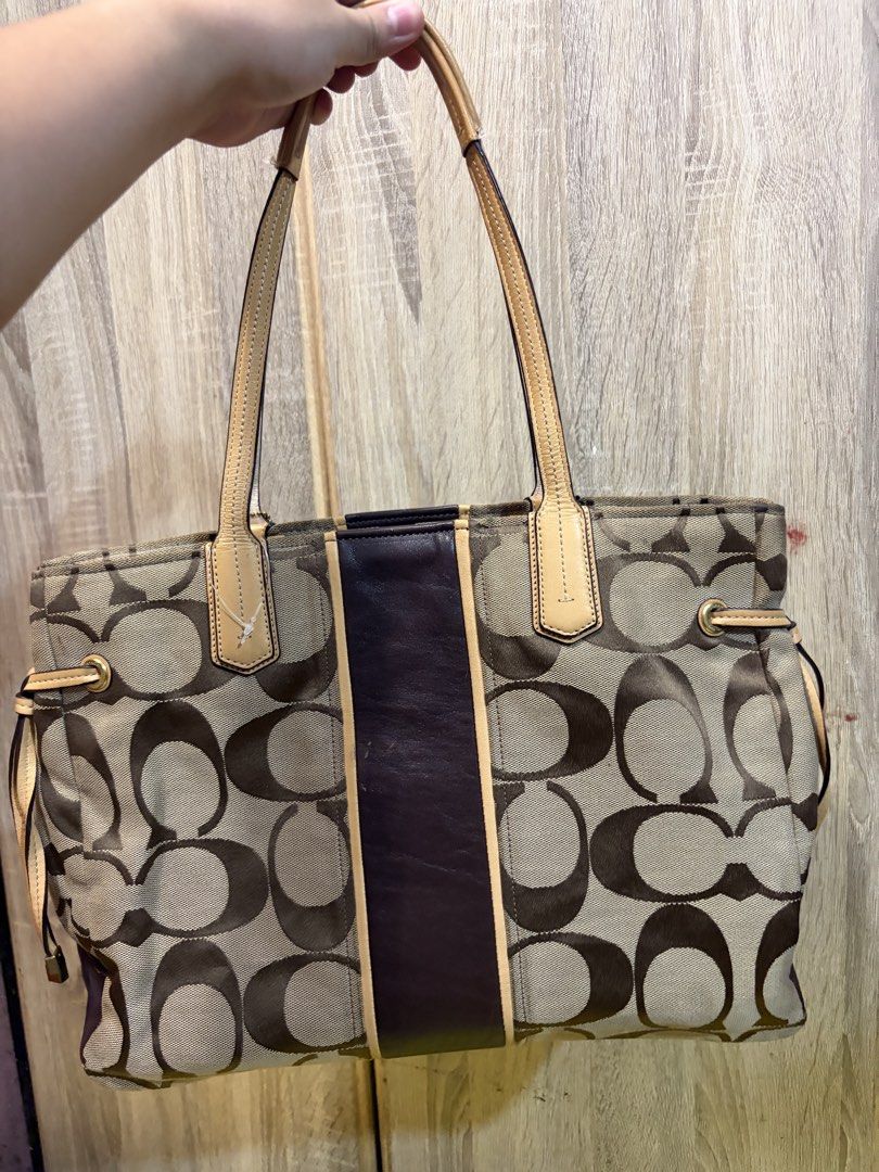Coach Signature C Monogram Tote Bag (Category: Luxury Bags & Wallets) located in Manila. Submitted by cb_curations (Listing ID 1462849187, Image 2). Description: - Classic Coach tote bag - Signature C monogram canvas with leather trim - Gold hardware - Coach horse and carriage logo - Interior zip pocket and compartments - Spacious for essentials - Great for everyday use.