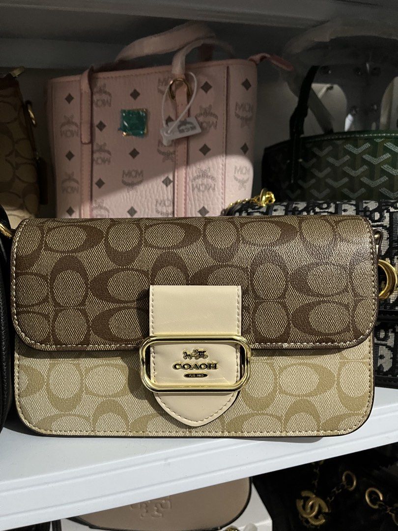 Coach Signature Canvas Shoulder Bag (Category: Shoulder Bags) located in Manila. Submitted by bratzmatilda (Listing ID 1462818937, Image 1). Description: - Coach shoulder bag - Signature C print in tan and beige .