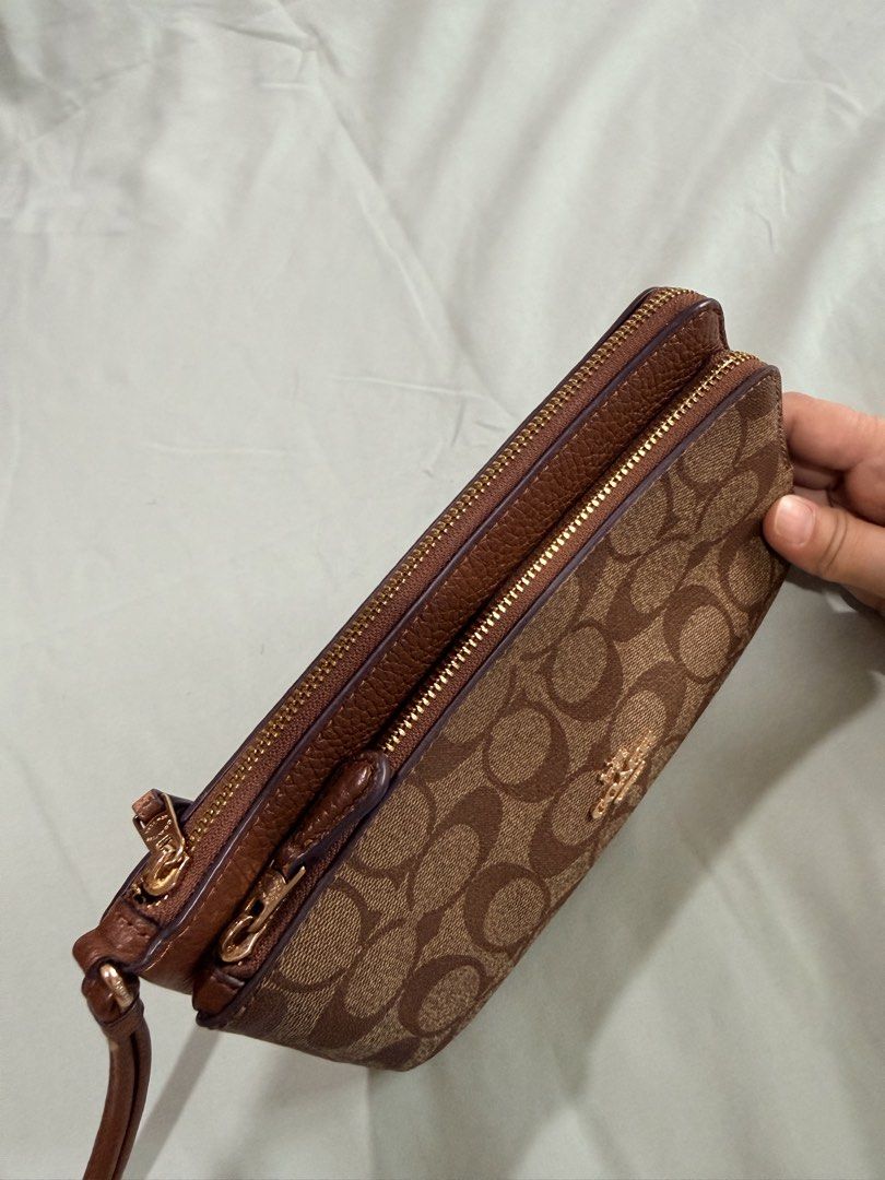 Coach Signature Double Zip Wristlet Brown Monogram (Category: Luxury Bags & Wallets) located in Manila. Submitted by purplebunnie1 (Listing ID 1462773276, Image 2). Description: - Authentic Coach wristlet in classic brown monogram print. - Features two secure zip compartments. - Includes a comfortable leather wrist strap. - Back panel made of solid brown pebbled leather. - Elegant gold-tone hardware. - Ample space for cards and daily essentials..