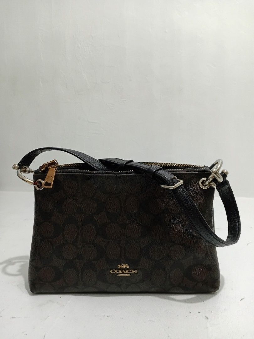 Coach Signature Monogram Canvas Shoulder Bag (Category: Luxury Bags & Wallets) located in Navotas City. Submitted by ms.soulana (Listing ID 1462875094, Image 1). Description: PREOWNED WellUsed Authentic Coach Monogram Canvas & Leather Shoulder bag Small Signature monogram print in dark brown - Black leather accents - Secure zipper closure - Perfect for everyday use Sign of Used Condition Flaws : 8.5/10.
