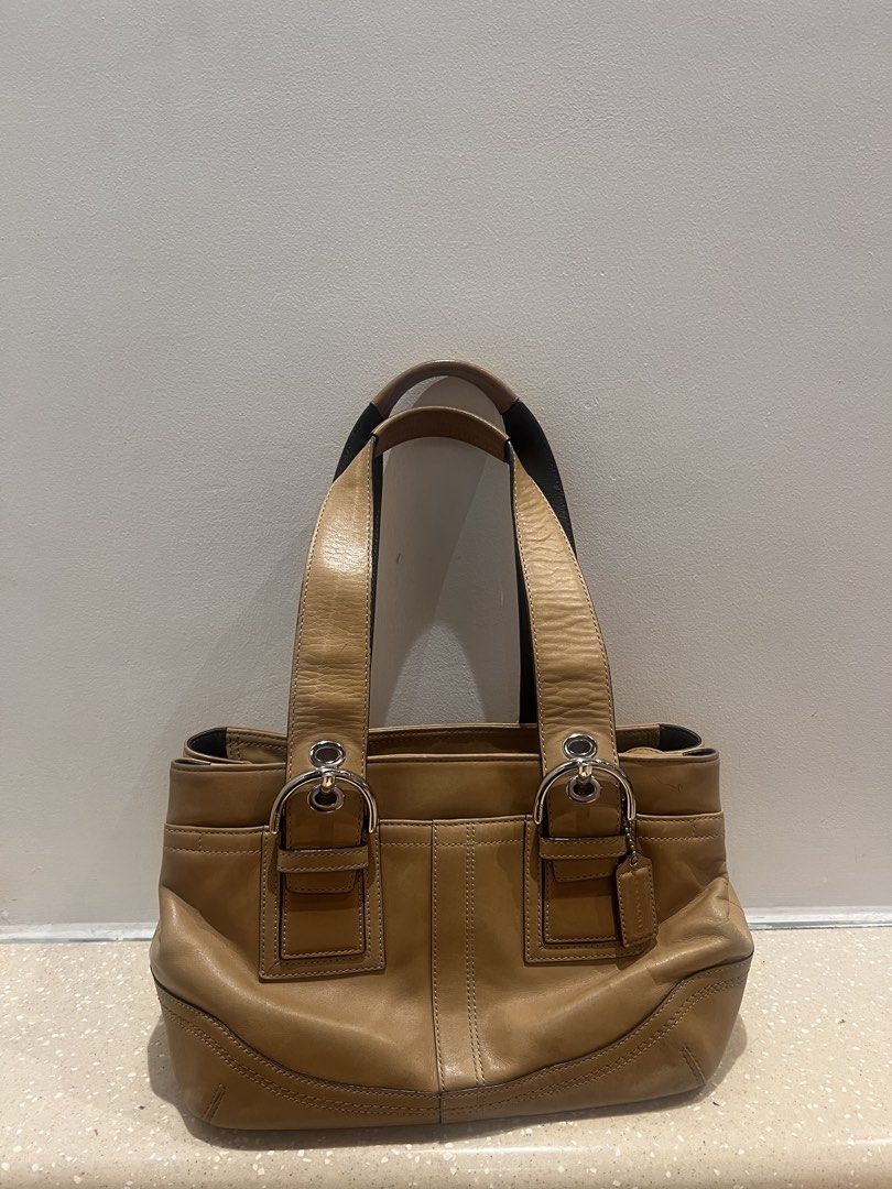 Coach Soho Tan Leather Tote Bag (Category: Luxury Bags & Wallets) located in Quezon City. Submitted by grandowl_294557 (Listing ID 1462813554, Image 1). Description: - Classic tan Coach leather tote - Beautiful patina from use - Spacious interior for essentials - Silver hardware details - Comfortable double top handles - Ideal everyday bag.