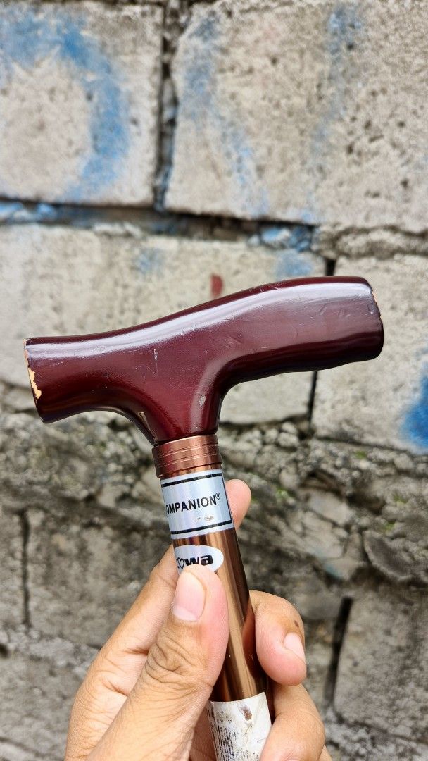 Companion Adjustable Walking Cane (Category: Medical Supplies & Tools) located in Paranaque City. Submitted by jtan1717838746 (Listing ID 1462782409, Image 1). Description: - Adjustable walking cane with a comfortable T-shaped handle. - Handle color: Deep Red. - Shaft color: Metallic Bronze. - Features adjustable height settings for a customized fit. - Includes a convenient wrist strap. - Provides excellent mobility assistance..