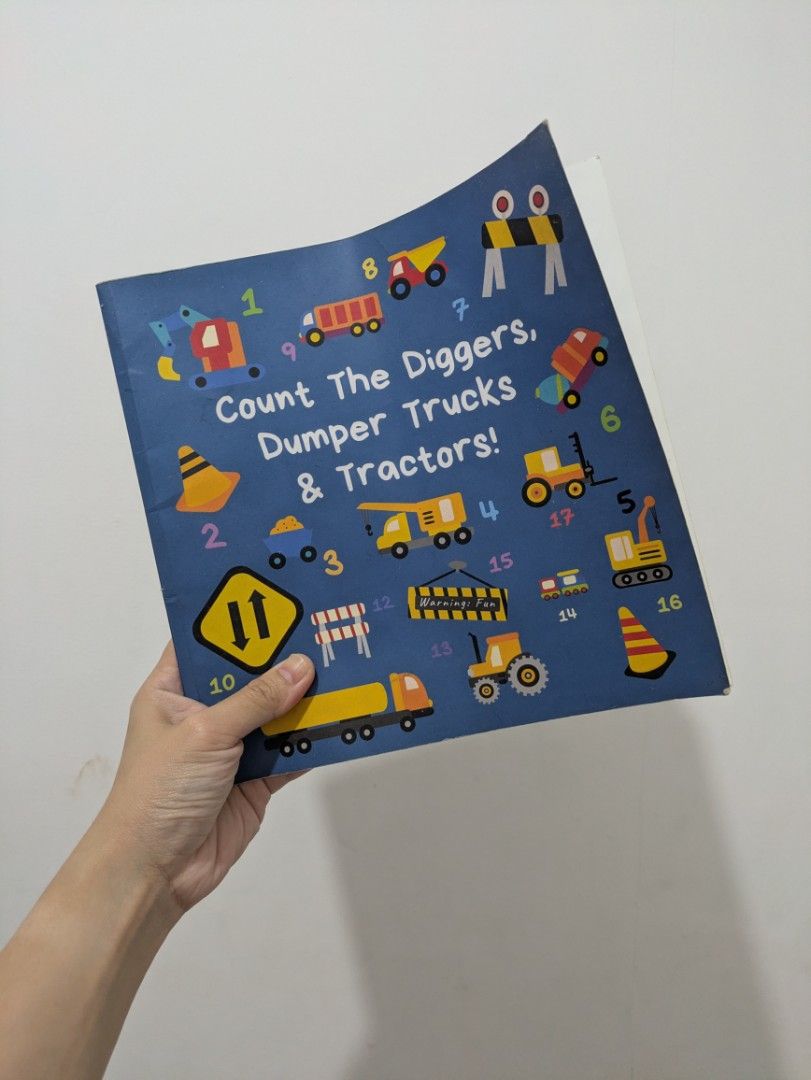 Construction Counting Book Diggers, Dump Trucks & Tractors for toddlers (Category: Children's Books) located in Quezon City. Submitted by lascosas.ph (Listing ID 1462708049, Image 1). Description: - Fun counting book for vehicle-loving kids! - Features diggers, dump trucks, and tractors. - Teaches numbers and vehicle types. - Bright, engaging illustrations. - Sturdy pages for little hands. - Perfect for early learning and reading practice..