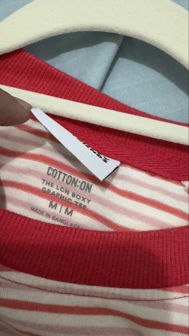 Cotton On Striped Graphic Tee M/M (Category: Shirts) located in Quezon City. Submitted by heyhaveaniceday (Listing ID 1462844890, Image 2). Description: - Cotton On graphic tee - Red and white stripe pattern - Features a cute red character graphic on the front - Boxy fit - Size: M/M - Made in Bangladesh.
